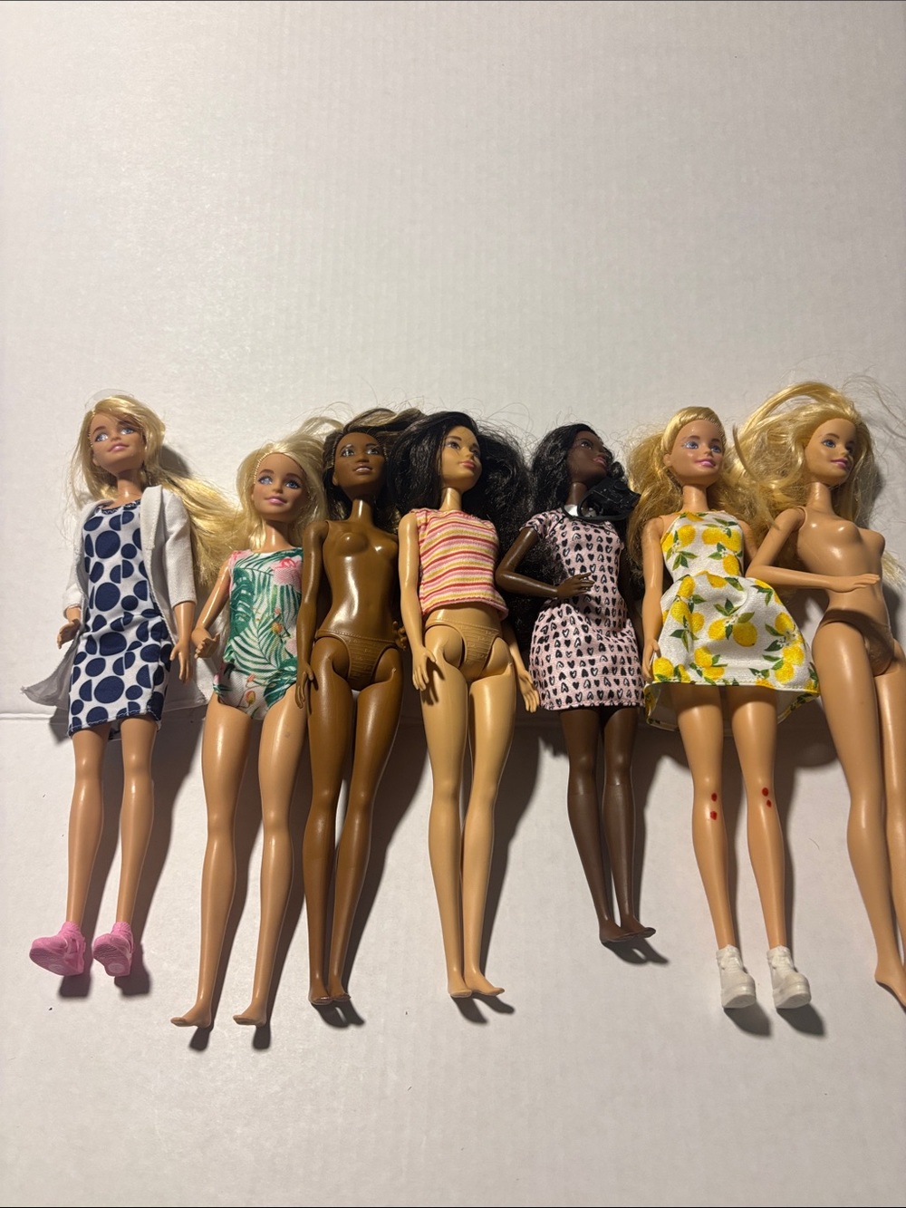 Lot of 7 Fashion Dolls with Mixed Outfits - Blonde, Brunette, Dark Skin Tones
